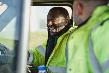 Delivery man in van smiling