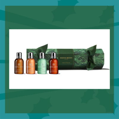 Green Christmas cracker with collection of bath and shower gels
