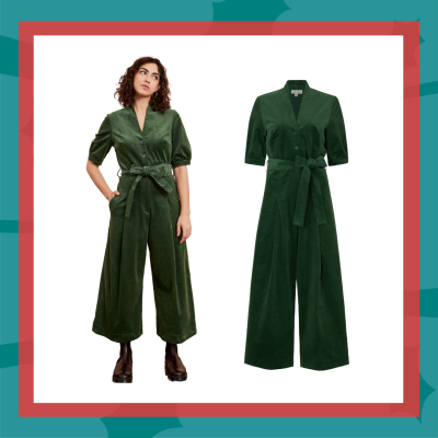 Woman dressed in a green jumpsuit with a bow around the waist.