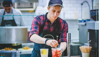Man making drinks in kitchen