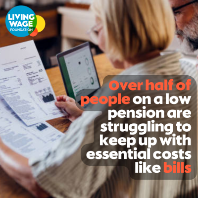 Photo of woman sitting at desk looking at bills with the text 'Over half of people on a low pension are struggling to keep up with essential costs like bills'