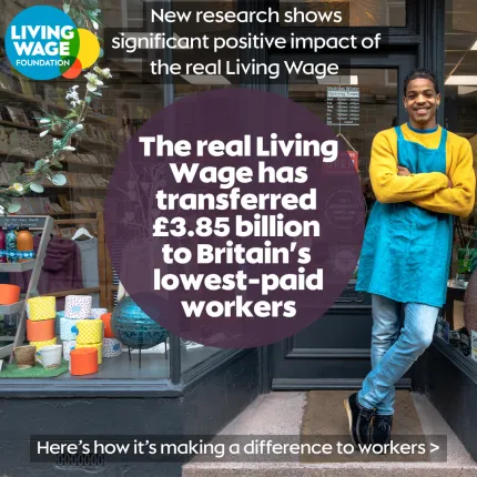 Worker smiling with text 'The real Living Wage has transferred £3.85 billion to Britain's lowest-paid workers'