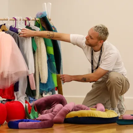 A man looks at costumes